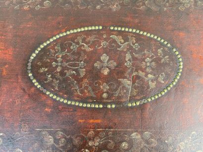 Wooden chest covered with studded burgundy...