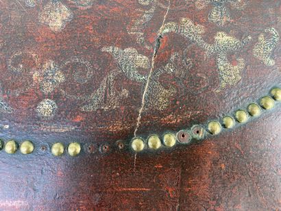 Wooden chest covered with studded burgundy...