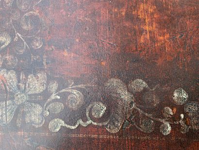 Wooden chest covered with studded burgundy...