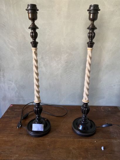 Pair of lamp feet in black lacquered composition...