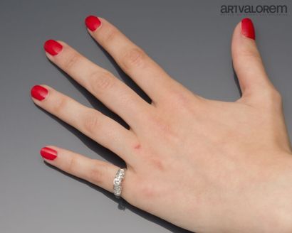 Platinum ring centered on a brilliant-cut...