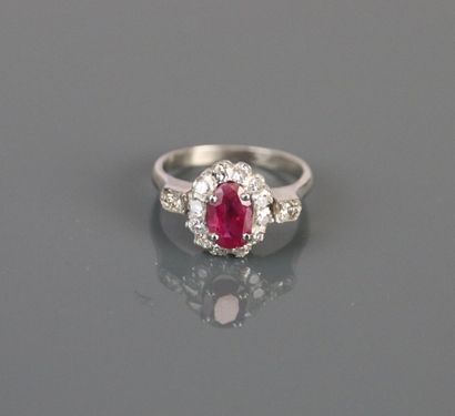 750°/°° white gold ring centered on an oval...