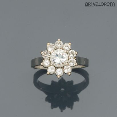 Platinum ring centered on a brilliant-cut...