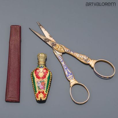 A pair of gold scissors with steel blades...