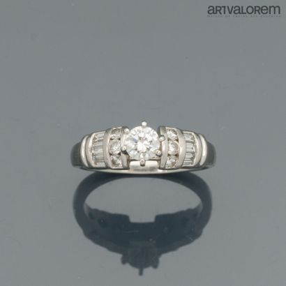 Platinum ring centered on a brilliant-cut...