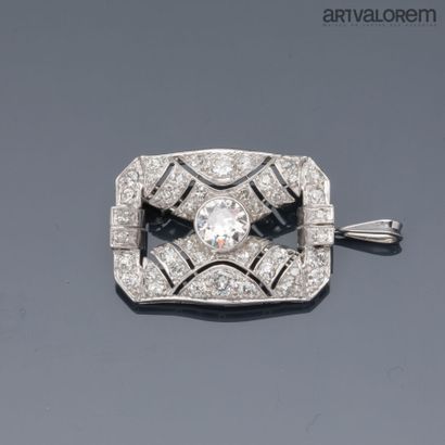 A platinum brooch pendant centered on a close-set...