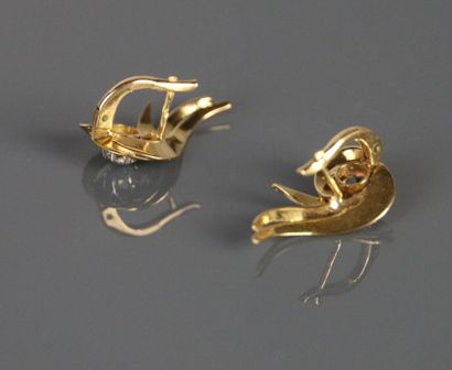 Pair of pierced ear clips in yellow gold...