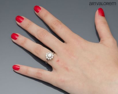 Platinum ring centered on a brilliant-cut...