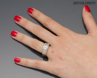 A platinum band ring paved with claw-set...