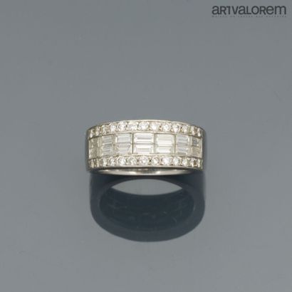 A platinum band ring paved with claw-set...