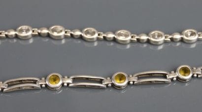 Two silver bracelets set with fancy stones....