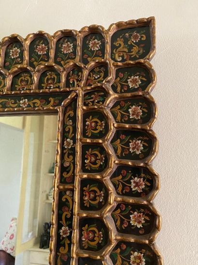 Large mirror, the rim adorned with painted...