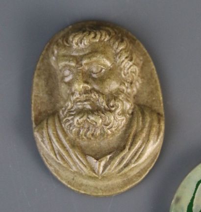 Lava stone medallion with carved decoration...