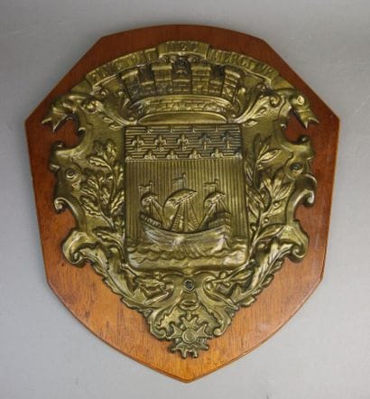 Embossed brass shield with the coat of arms...
