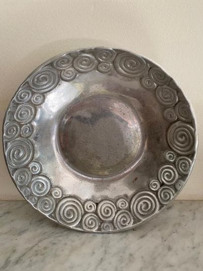 Circular pewter dish, wing decorated with...