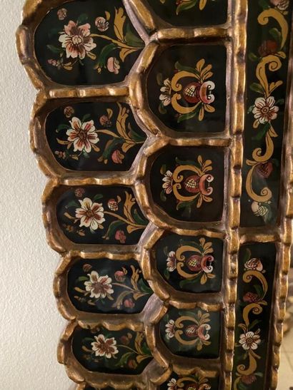 Large mirror, the rim adorned with painted...