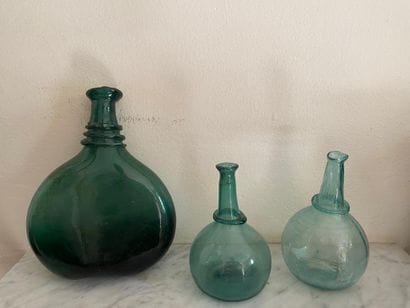 Set of three high-necked globular carafes...