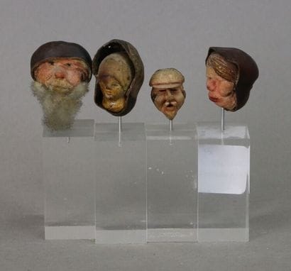 Four heads carved in chestnut, featuring...