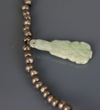 Necklace with silver beads holding engraved...