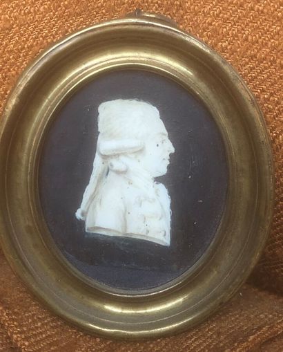 Three profile miniatures of a man and a woman....