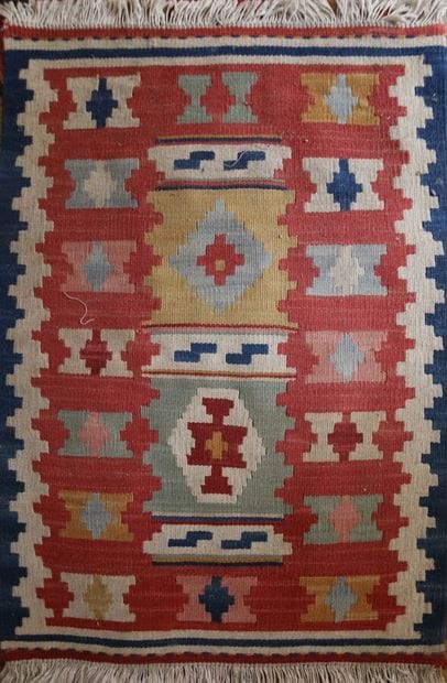 Three Kilim rugs in wool with geometric motifs.
115...