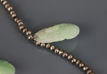 Necklace with silver beads holding engraved...