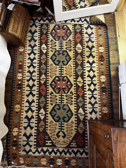Three Kilim rugs in wool with geometric motifs.
115...