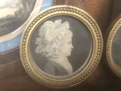Three profile miniatures of a man and a woman....