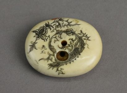 JAPAN,
Oval-shaped Netsuke in carved marine...