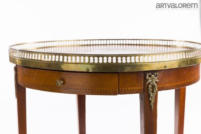 Louis XVI-style pedestal table with two brass-belted...