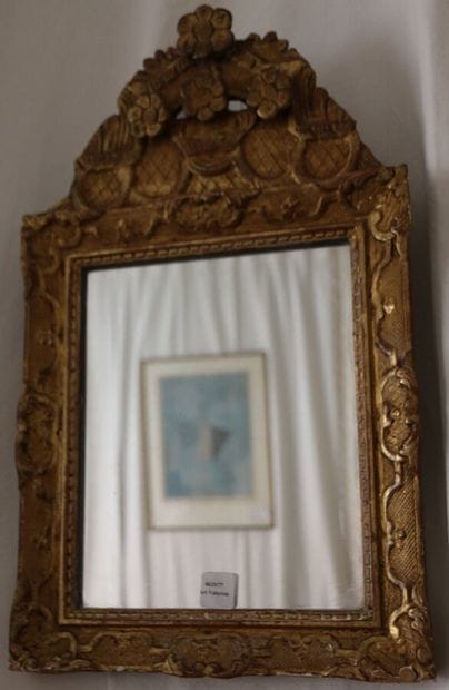 Gilded and carved wood mirror, the pediment...