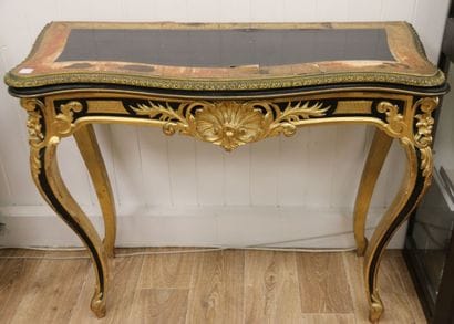 Molded and carved console table in blackened...