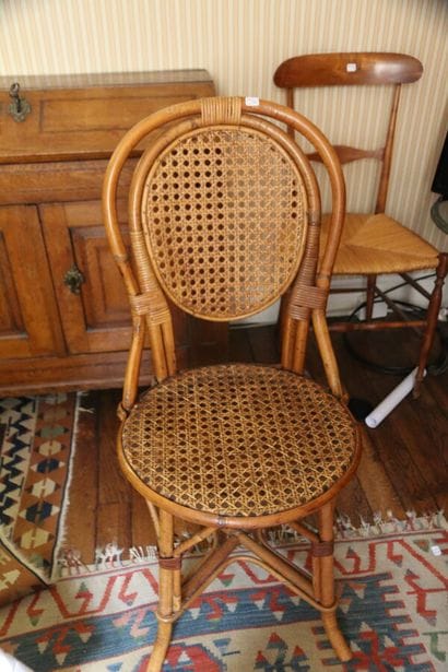 A wooden chair with banded back and straw...