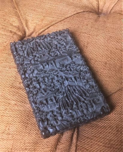 A stained wood cigarette case with carved...