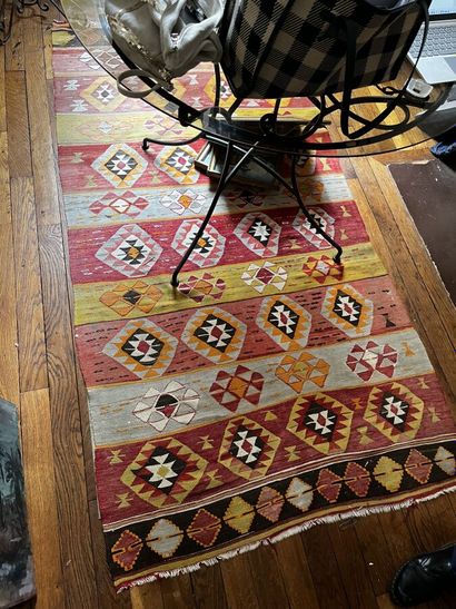 Three Kilim rugs in wool with geometric motifs.
115...