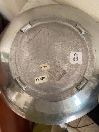 Circular pewter dish, wing decorated with...