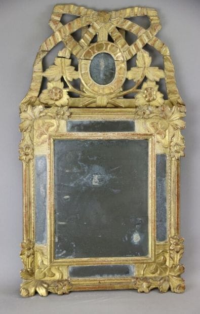 Gilded wood mirror with foliate staples on...