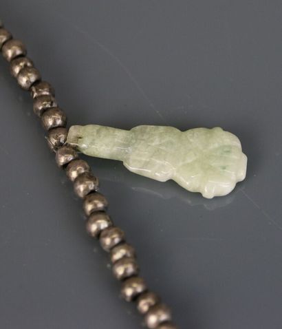 Necklace with silver beads holding engraved...