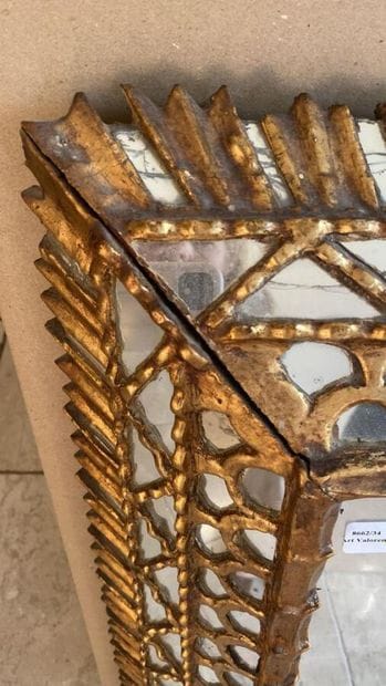 Upside-down mirror in gilded wood, decorated...