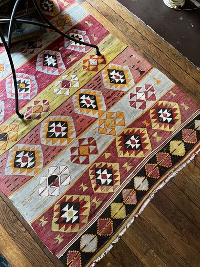 Three Kilim rugs in wool with geometric motifs.
115...