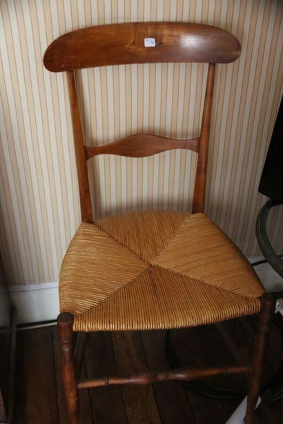 A wooden chair with banded back and straw...