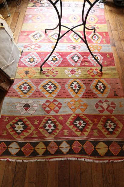 Three Kilim rugs in wool with geometric motifs.
115...