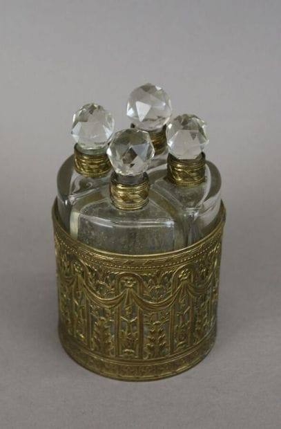 Small cabaret comprising four cut-glass flasks,...