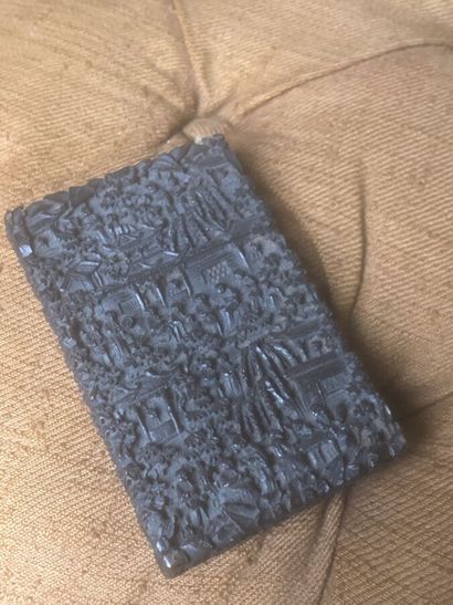 A stained wood cigarette case with carved...