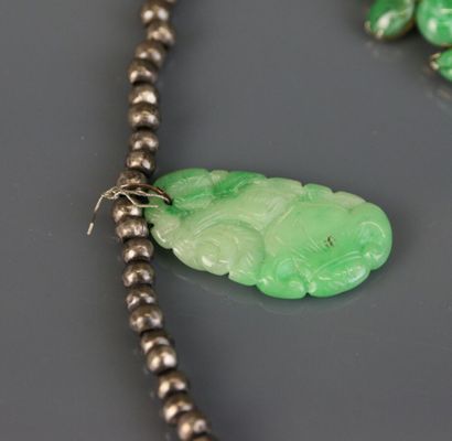 Necklace with silver beads holding engraved...