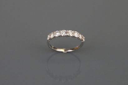Half wedding band in 750°/°° white gold paved...