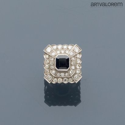 Platinum ring centered on an emerald-cut...