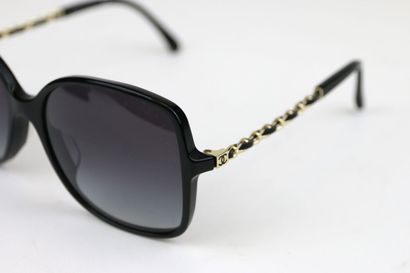 CHANEL
Pair of black resin and gold metal...