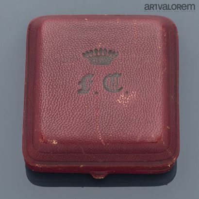 Two large buttons engraved with M.C. under...