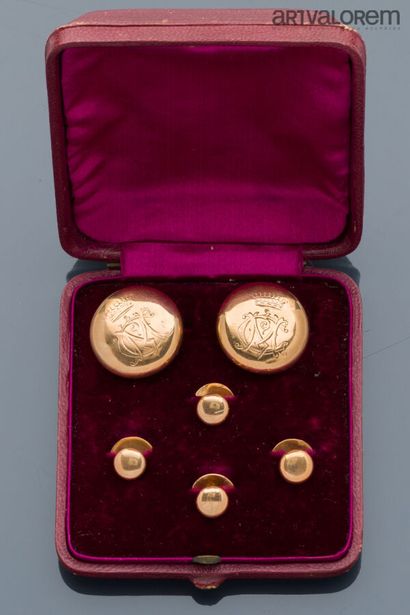 Two large buttons engraved with M.C. under...